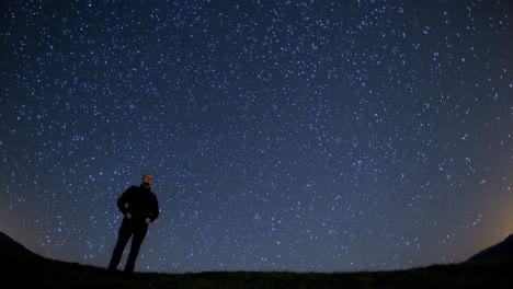 man looking up at the night sky