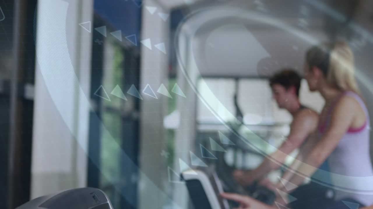 Female exerciser on right touching console and initiating cardio while HUD graphics adjusting pace