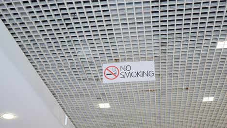 no smoking sign on a white ceiling