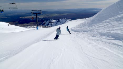 alpine skiing and snowboarding on gentle slope at mount ruapehu, ski resort