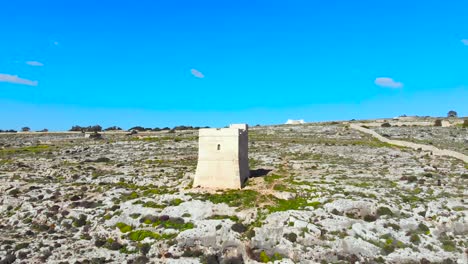 drone shot over rocks in nature and towards a tower 1