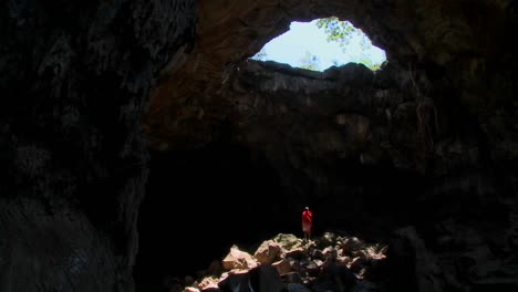 un guerrero masai se baña en un charco de luz en una cueva en kenia