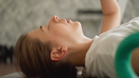 tired woman lies down to rest on floor closeup. fatigued lady with headache rests lying on mat at home. athlete takes break after physical overload