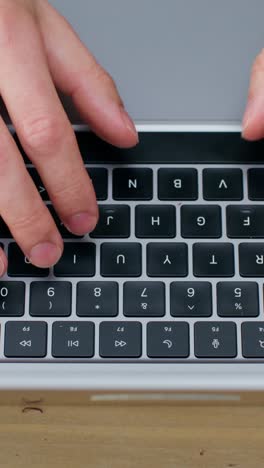 person typing on a laptop keyboard