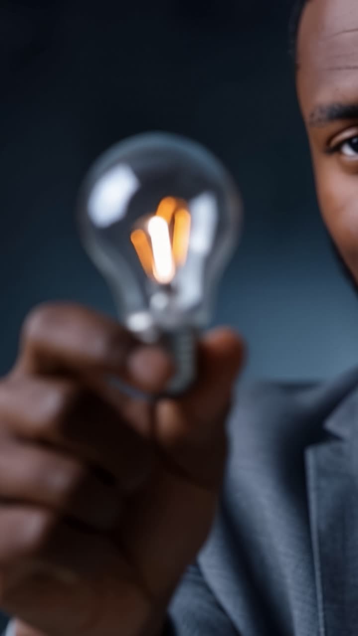 A Close-Up of a Hand Holding a Glowing Light Bulb, Symbolizing Ideas, Innovation, and the Power of Illumination in a Creative and Inspirational Context