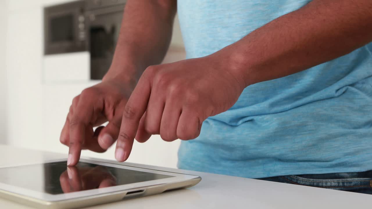 Happy casual man using digital tablet
