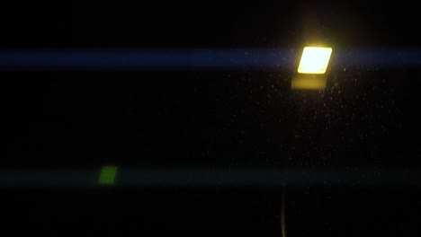 las linternas brillan por la noche con pequeños copos de nieve