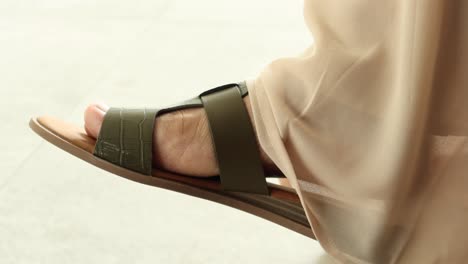 woman's foot in stylish green sandals