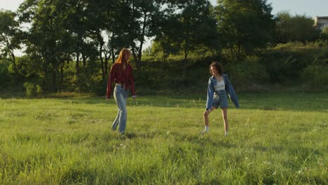 two women walking through a field