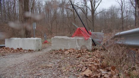 blocked hiking trail on overgrown nature road do not enter