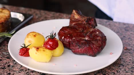 delicious grilled steak with roasted potatoes and tomatoes