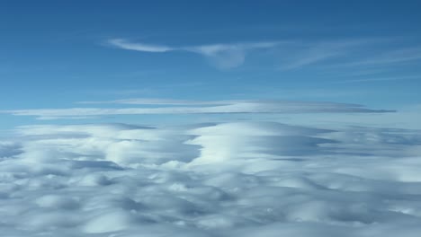 close view of some dangerous lenticular clouds over madrid mountain range, shot from a jet cockpit at 6000m high