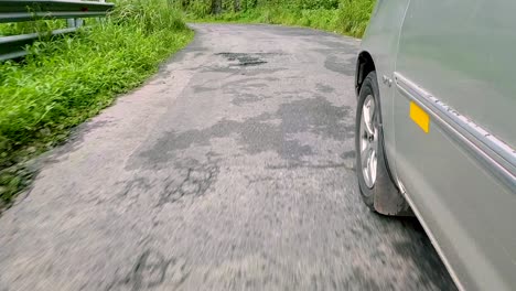 follow shot of car running around the hair pin bend in the mountains in vagamon, kerala, india