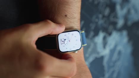 male hands checking new modern apple watch 7 functions by pushing buttons and touching screen