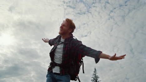 male hiker feeling freedom in nature