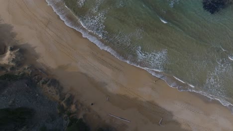 Drone-Aéreo-De-Arriba-Hacia-Abajo-Aguas-Limpias-Del-Mar-Que-Alcanzan-La-Costa-De-Arena-Blanca-En-Cámara-Lenta