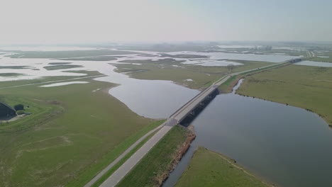Aerial drone view of the road at the watery landscape in the Netherlands