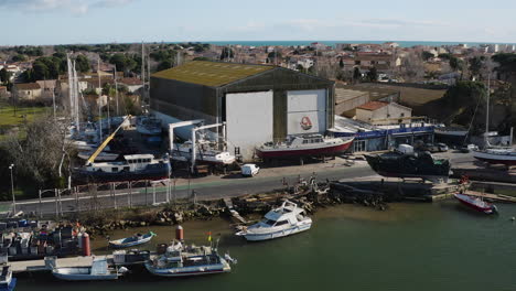 giant hangar in the grau d'agde ship repair yard aerial drone shot sunny day