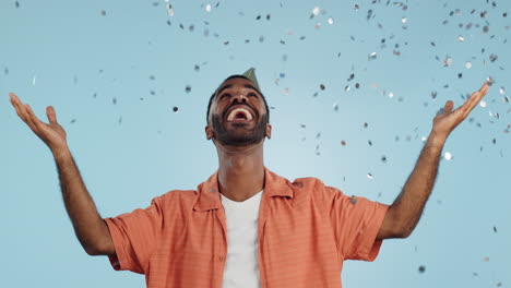 Man,-birthday-party-hat-and-confetti-in-studio