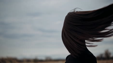 woman with flowing hair in a field