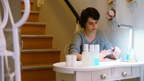 woman applying nail polish to her finger nails