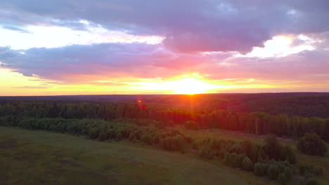 sunset over a field and forest