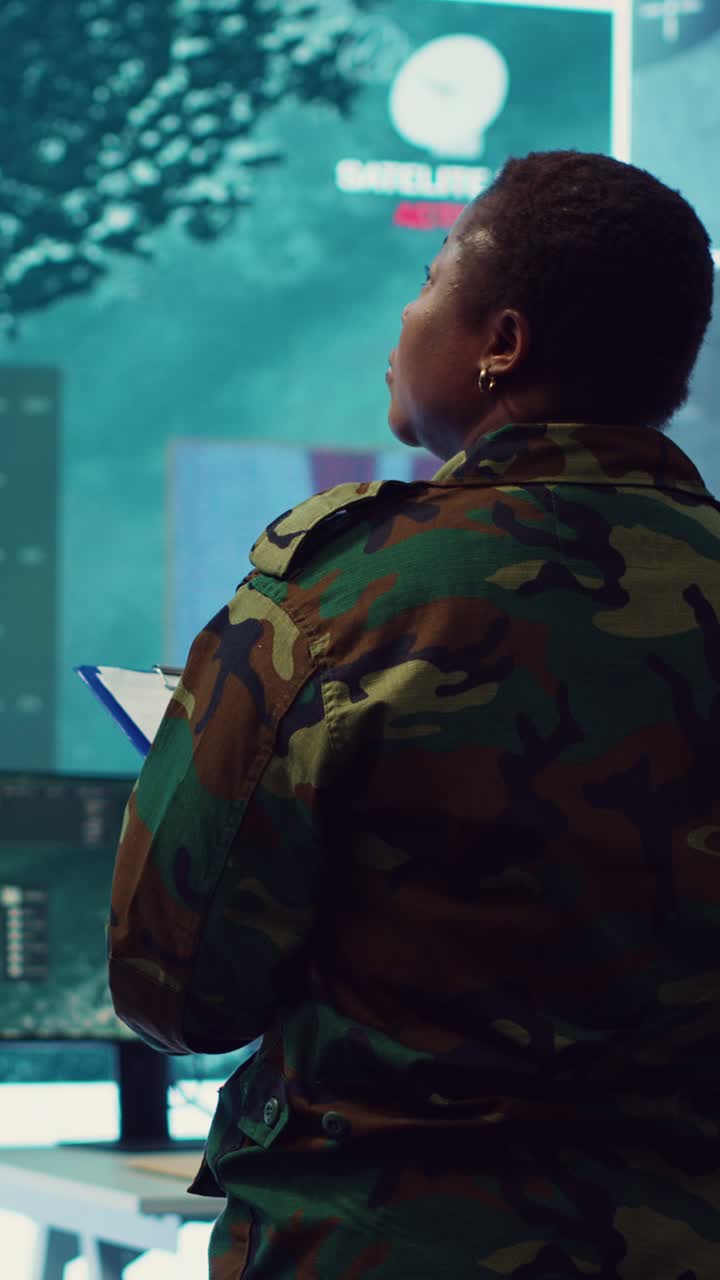 Woman Soldier Monitoring Data in Military Control Room