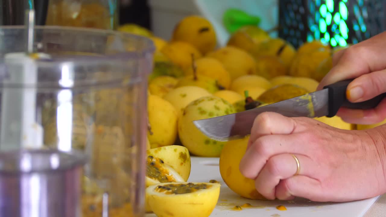 Cutting passion fruit for processing in a home kitchen on Hawaii