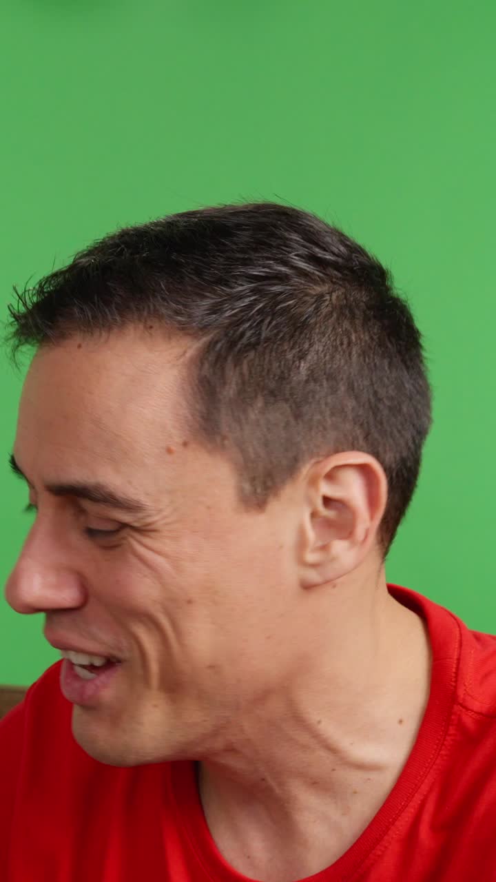 Bored man flipping channels on green screen