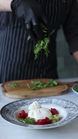 chef preparing burrata with arugula