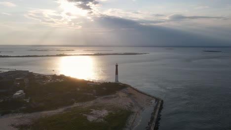 a high-flying, 4k drone shot of the barnegat lighthouse, located on the northern tip of long beach island in ocean county, new jersey, u