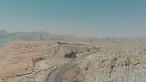 aerial view of makran coastal highway road near beach of gulf of oman. follow shot