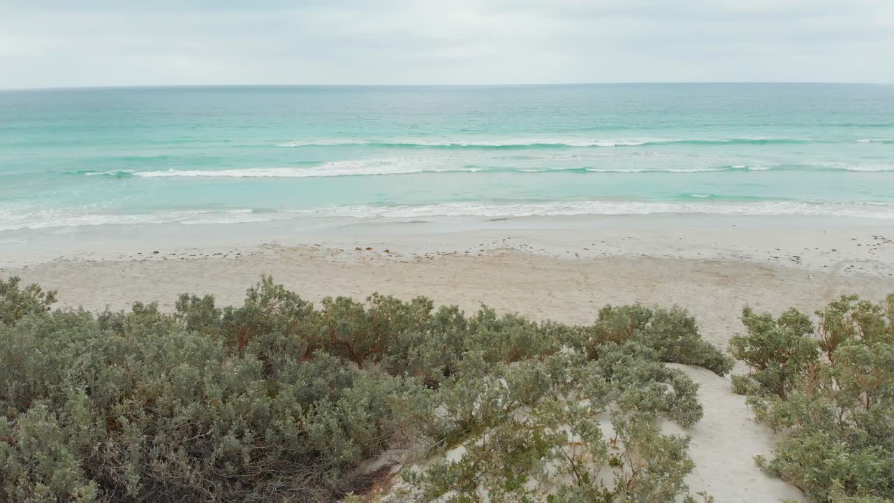 Flying backwards at Tarcoola beach over dunes Geraldton, aerial