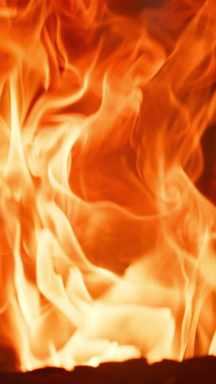 Close up of a strong flame in a fireplace. Vertical