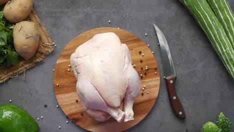 raw chicken with vegetables on a cutting board