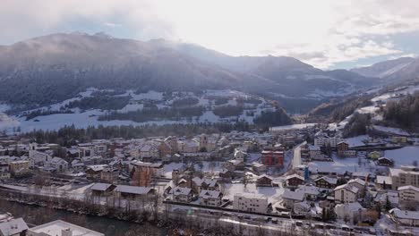 snowy village in illanz, swiss alps, with mountains and morning light