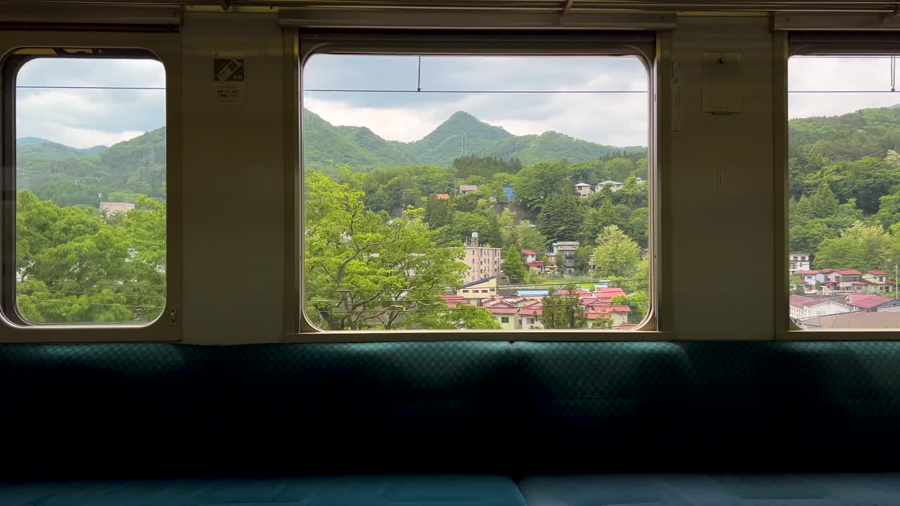 Stunning scenery rolling outside train window in Japan passing through rural countryside