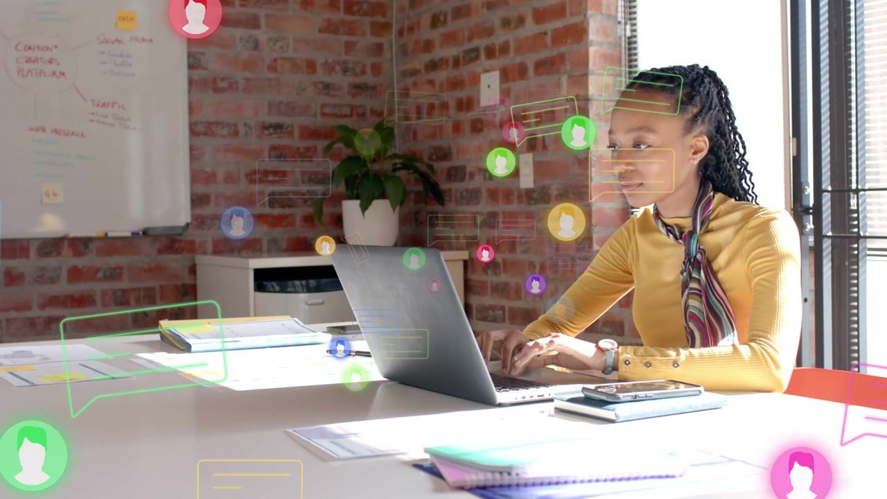 Woman typing on laptop in office, creating floating user icons and messages, showing engagement