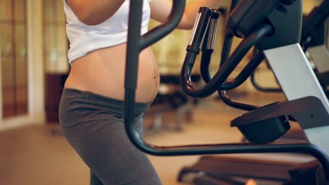 Active-pregnant-woman-exercise-in-fitness-center.