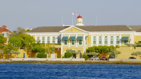 the house of parliament in curacao with yellow exterior facade - wide shot