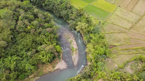 birds eye drone view of natural winding river in tropical country of indonesia