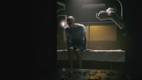 a bald man wakes up in the empty operation room