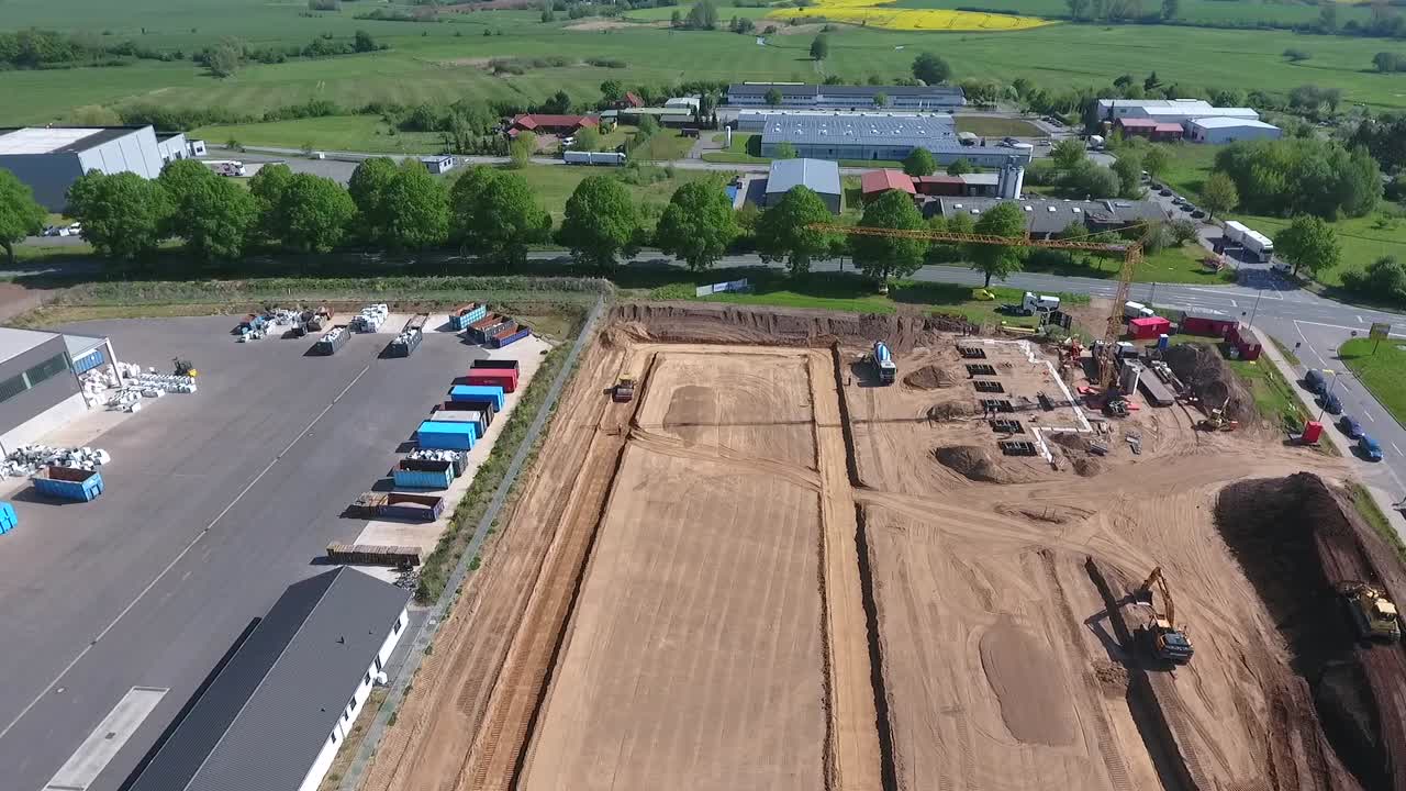 un dron sobrevuela una gran obra en la que se está construyendo una enorme nave de producción