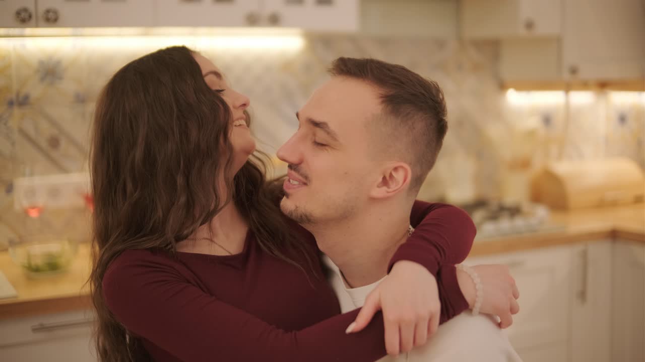 A loving couple is spending time at home.