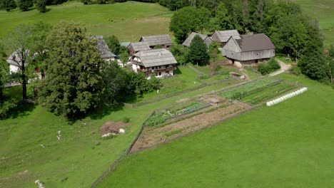 aerial view of traditional alpine farm in european alps, jezersko, slovenia