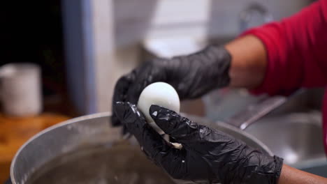 cook peels shell from hard boiled egg, slow motion hd