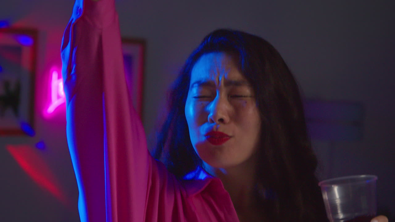 pareja de jóvenes divirtiéndose bailando y bebiendo alcohol en una fiesta en casa juntos 3