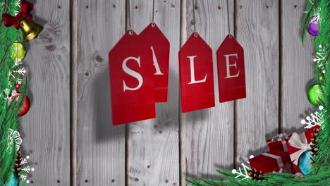 red sale tags hanging against wood with festive decorations