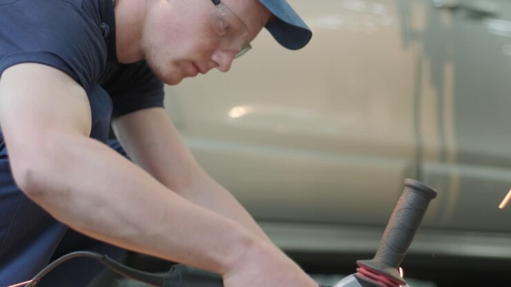 Auto service, car maintenance and repair with electric grinder in 4K