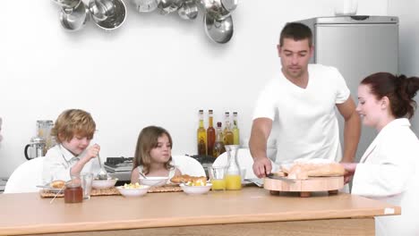 young family at home having breakfast